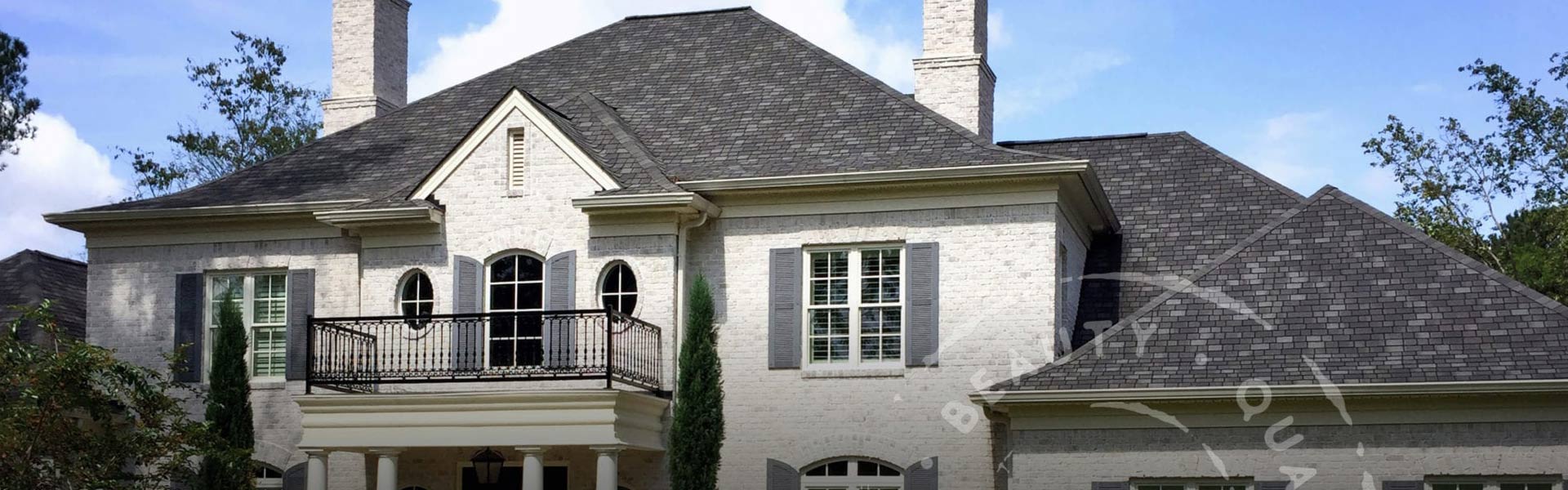 Home with a dark gray shingle roof